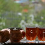 2 clear glass jars with brown liquid